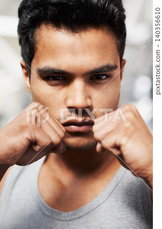 Man, portrait and boxing with confidence, closeup and fists ready to punch in match for training and exercise. Male person, workout and focus in gym, mma and boxer for sports and combat for defence Man, portrait and boxing with confidence, closeup and fists ready to punch in match for training and exercise. Male person, workout and focus in gym, mma and boxer for sports and combat for defence 140356610
