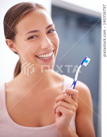 Portrait, smile and toothbrush for dental care with woman in bathroom of home for teeth whitening. Face, oral hygiene and happy young person in apartment to prevent tooth decay or gum disease Portrait, smile and toothbrush for dental care with woman in bathroom of home for teeth whitening. Face, oral hygiene and happy young person in apartment to prevent tooth decay or gum disease 140356797