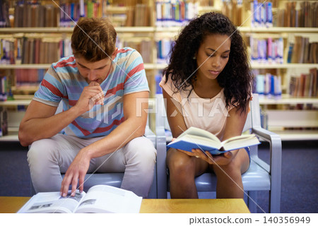 Reading, university and students with books in library for knowledge, learning and studying at college. Academic, education and man and woman with textbook for literature, research and information Reading, university and students with books in library for knowledge, learning and studying at college. Academic, education and man and woman with textbook for literature, research and information 140356949