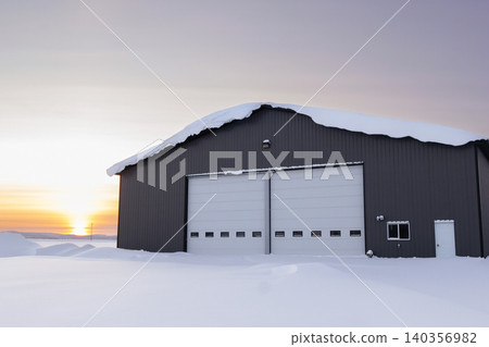 Warehouse in snow, industrial building in sunset light in winter. 140356982