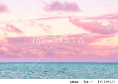 Tropical sunset with pink cloudy sky and peaceful water. 140356988