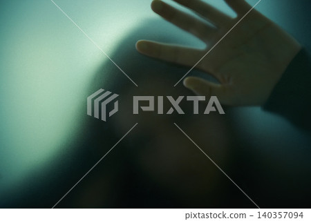 Scary, mystery and person with hand on glass, window or trapped in home. Ghost, shadow and figure in horror, drama or creepy aesthetic with silhouette in house with spooky fog or smoke on screen Scary, mystery and person with hand on glass, window or trapped in home. Ghost, shadow and figure in horror, drama or creepy aesthetic with silhouette in house with spooky fog or smoke on screen 140357094