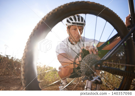 Checking, man and bicycle chain by wheel, nature and mountain biking in countryside. Male person, workout and lens flare for fitness or exercise, hobby and sports for adventure and tyre inspection Checking, man and bicycle chain by wheel, nature and mountain biking in countryside. Male person, workout and lens flare for fitness or exercise, hobby and sports for adventure and tyre inspection 140357098
