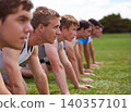 Group, men and field for push up with fitness, training and health with friends for sport, challenge or wellness. People, athlete and teamwork with exercise, workout and together on field for muscle 140357101