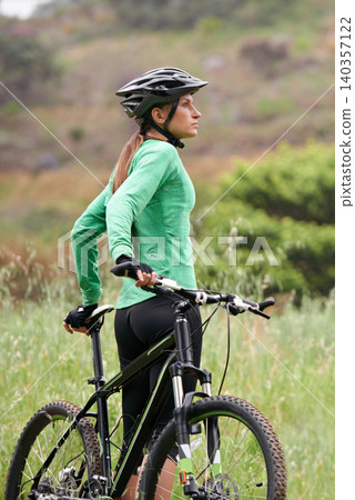 Fitness, thinking and woman cyclist in countryside for adventure, cardio workout or discovery. Exercise, nature or break and confident young person with bike for cycling hobby outdoor in nature Fitness, thinking and woman cyclist in countryside for adventure, cardio workout or discovery. Exercise, nature or break and confident young person with bike for cycling hobby outdoor in nature 140357122