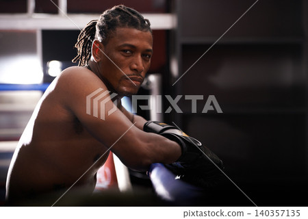 Portrait, fitness and black man boxer in ring at gym for combat sports training or competition. Exercise, boxing or fighting with shirtless young athlete on break from intense self defense workout Portrait, fitness and black man boxer in ring at gym for combat sports training or competition. Exercise, boxing or fighting with shirtless young athlete on break from intense self defense workout 140357135