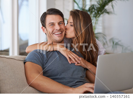 Laptop, portrait and woman kissing man on sofa networking on social media, website or internet. Happy, love and female person hugging husband reading online blog with computer in living room at home. Laptop, portrait and woman kissing man on sofa networking on social media, website or internet. Happy, love and female person hugging husband reading online blog with computer in living room at home. 140357161