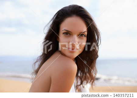 Beach, sea and portrait of woman on tropical vacation, adventure or holiday for travel. Happy, nature and young female person with positive attitude by ocean on summer weekend trip by island. 140357211