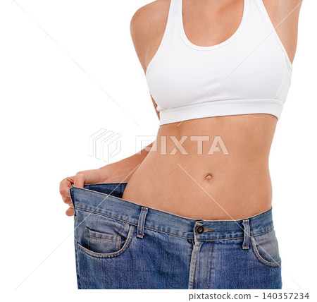 Jeans, stomach and woman in studio with weight loss for health benefits, diet and fitness goals. Female person, pants and body transformation on white background for progress, results and comparison Jeans, stomach and woman in studio with weight loss for health benefits, diet and fitness goals. Female person, pants and body transformation on white background for progress, results and comparison 140357234