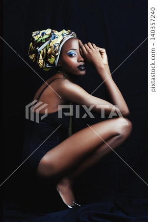 Black woman, beauty and portrait with fashion, turban and makeup in studio. Cosmetics, trendy and afro style with African female person from Kenya with traditional head dress with black background Black woman, beauty and portrait with fashion, turban and makeup in studio. Cosmetics, trendy and afro style with African female person from Kenya with traditional head dress with black background 140357240