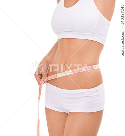 Woman, abdomen and tape in studio for health, measuring and fitness for weight loss. Female person, results on progress and nutrition for slim body, stomach and workout closeup with white background Woman, abdomen and tape in studio for health, measuring and fitness for weight loss. Female person, results on progress and nutrition for slim body, stomach and workout closeup with white background 140357246