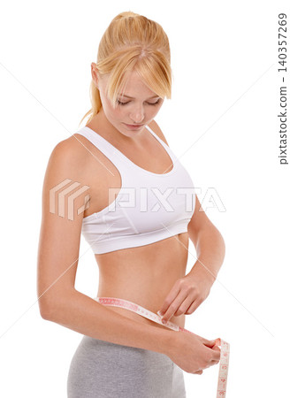 Woman, stomach and tape in studio for weight loss, measuring and fitness for health. Female person, results on progress and nutrition for slim body, abdomen and workout isolated with white background 140357269