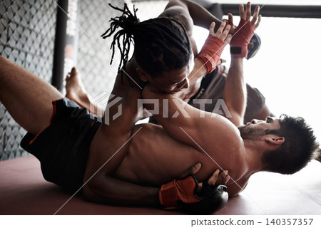 Fight, wrestling and men on floor for kickboxing competition, challenge and fitness with sports in gym. Match, strong fighter and resilience in exercise, sparring practice or power in battle together Fight, wrestling and men on floor for kickboxing competition, challenge and fitness with sports in gym. Match, strong fighter and resilience in exercise, sparring practice or power in battle together 140357357