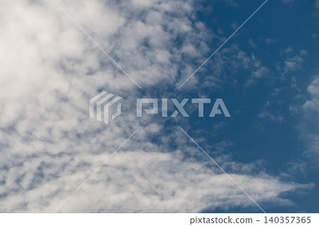Changing textures illuminate sky scenery. Different cloud formations contrast with vivid blue backdrop. Weather varies through shifting textures with soft light and clouds Changing textures illuminate sky scenery. Different cloud formations contrast with vivid blue backdrop. Weather varies through shifting textures with soft light and clouds 140357365