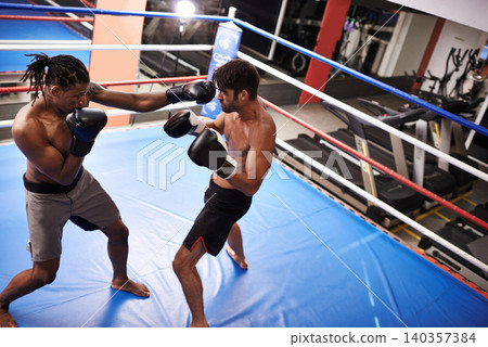 Men, fighting and boxing ring for fitness competition in gym for endurance development, performance or training. Male people, punch and combat sport together for cardio battle, defense or practice 140357384