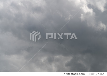 Clouds shift dramatically. Overcast sky with moving layers. Dark gray clouds create striking visual contrast. Thick gray cloud formations flow across scene dynamically Clouds shift dramatically. Overcast sky with moving layers. Dark gray clouds create striking visual contrast. Thick gray cloud formations flow across scene dynamically 140357464
