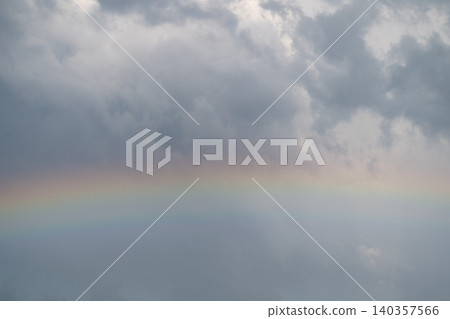 Colorful spectrum against gray sky. Bright rainbow contrasts stormy gray clouds vividly. Photographer captures striking rainbow with bold colors amid gloomy storm Colorful spectrum against gray sky. Bright rainbow contrasts stormy gray clouds vividly. Photographer captures striking rainbow with bold colors amid gloomy storm 140357566