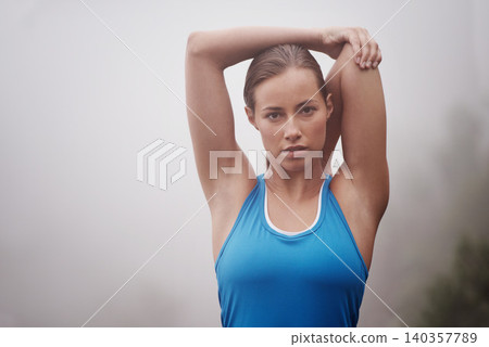 Portrait, fitness and woman stretching outdoor, wellness or sports on mockup space with fog. Face, serious person or warm up arms in nature with mist for exercise, training or workout for body health Portrait, fitness and woman stretching outdoor, wellness or sports on mockup space with fog. Face, serious person or warm up arms in nature with mist for exercise, training or workout for body health 140357789