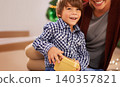 Child, parent and portrait with Christmas gift for festive season celebration for bonding, giving or holiday. Female person, boy and present box in Canada at tree for vacation, happiness or package 140357821