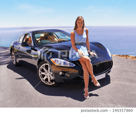 Woman, portrait and car for luxury in nature, summer and sitting on motorcar for journey and transportation. Girl, serious and road trip with vehicle in sun, outdoor and beautiful person to relax Woman, portrait and car for luxury in nature, summer and sitting on motorcar for journey and transportation. Girl, serious and road trip with vehicle in sun, outdoor and beautiful person to relax 140357860