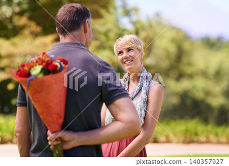 Surprise, happy couple and gift of flowers outdoor in nature, bonding or date on valentines day. Bouquet, man and woman with present for love, care or romantic connection of people at garden together 140357927