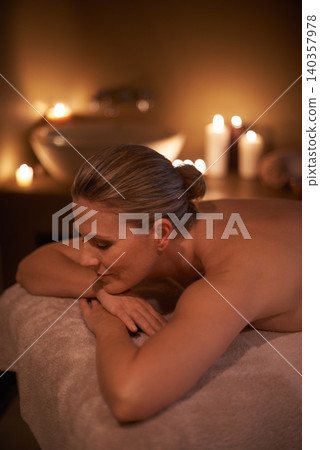 Massage, relax and woman with holiday, spa and stress relief with hospitality industry and weekend break. Person, customer and girl on a table and wellness with beauty and happy with detox or candles 140357978