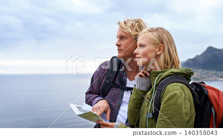 Couple, thinking and map by ocean for hiking, direction or location on outdoor adventure together in nature. Young man and woman reading tour or travel guide for route, path or destination on hike 140358043