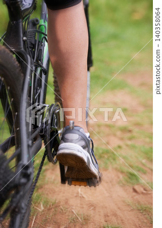 Cycling, legs and person on fast bicycle outdoor for exercise, workout or fitness for sports. Mountain bIke, speed and shoes of bicyclist in nature to travel on transport, journey or closeup of back Cycling, legs and person on fast bicycle outdoor for exercise, workout or fitness for sports. Mountain bIke, speed and shoes of bicyclist in nature to travel on transport, journey or closeup of back 140358064