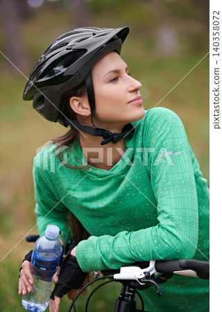 Thinking, bicycle and woman in nature to exercise with water bottle outdoor for hydration. Bicyclist, cycling and female person on bike to travel on journey, adventure or workout for sports in summer Thinking, bicycle and woman in nature to exercise with water bottle outdoor for hydration. Bicyclist, cycling and female person on bike to travel on journey, adventure or workout for sports in summer 140358072