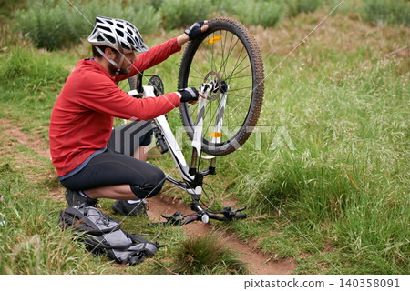 Exercise, bike and fixing wheel with man cyclist in countryside for sports, hobby or cardio training. Fitness, cycling or tyre puncture with young athlete and bicycle outdoor in nature for workout Exercise, bike and fixing wheel with man cyclist in countryside for sports, hobby or cardio training. Fitness, cycling or tyre puncture with young athlete and bicycle outdoor in nature for workout 140358091