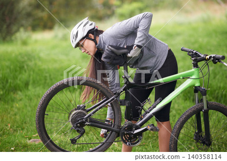Fitness, bike and flat wheel with woman cyclist in countryside for sports, hobby or cardio training. Exercise, cycling or tyre puncture with young athlete fixing bicycle outdoor in nature for workout Fitness, bike and flat wheel with woman cyclist in countryside for sports, hobby or cardio training. Exercise, cycling or tyre puncture with young athlete fixing bicycle outdoor in nature for workout 140358114