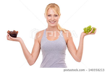 Portrait, smile and woman with choice of fruit, chocolate or healthy eating food to lose weight in studio. Happy, face and girl with apple vs candy, decision for diet or nutrition on white background Portrait, smile and woman with choice of fruit, chocolate or healthy eating food to lose weight in studio. Happy, face and girl with apple vs candy, decision for diet or nutrition on white background 140358213