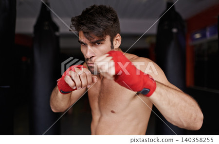 Man, portrait and practice for boxing in gym, fitness and topless for exercise and workout. Male person, bodybuilder and punching bag for challenge or athlete, training and serious for competition Man, portrait and practice for boxing in gym, fitness and topless for exercise and workout. Male person, bodybuilder and punching bag for challenge or athlete, training and serious for competition 140358255