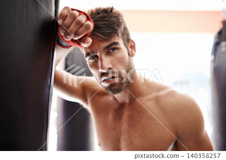 Man, thinking and fighter in gym for combat, training and determination with gloves for match. Male athlete, mma and boxer at fitness studio for practicing for competition, challenge and kickboxing Man, thinking and fighter in gym for combat, training and determination with gloves for match. Male athlete, mma and boxer at fitness studio for practicing for competition, challenge and kickboxing 140358257