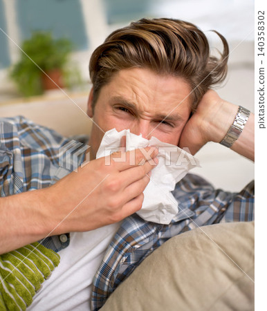 Flu, tissue and portrait of man on sofa with cold, influenza and virus infection at home. Sick, allergies and person with handkerchief or toilet paper for sneeze, bacteria or sinusitis in living room Flu, tissue and portrait of man on sofa with cold, influenza and virus infection at home. Sick, allergies and person with handkerchief or toilet paper for sneeze, bacteria or sinusitis in living room 140358302