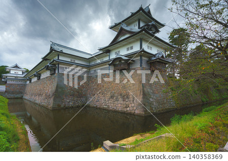 Kanazawa, Japan - Oct 6 2024, panoramic view of facade of Kanazawa Castle with the moat in the foreground, on a cloudy day, without people, at daytime, Kanazawa, Japan Kanazawa, Japan - Oct 6 2024, panoramic view of facade of Kanazawa Castle with the moat in the foreground, on a cloudy day, without people, at daytime, Kanazawa, Japan 140358369