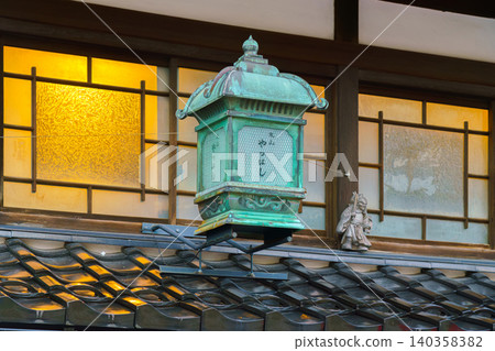 Kanazawa, Japan - Oct 6 2024, Close-up view of an antique bronze street lamp with patina on the facade of one of the houses in the old district of Kanazawa, Japan Kanazawa, Japan - Oct 6 2024, Close-up view of an antique bronze street lamp with patina on the facade of one of the houses in the old district of Kanazawa, Japan 140358382