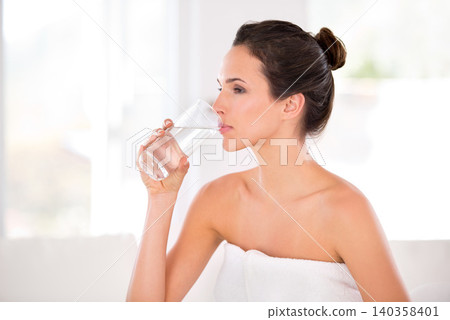 Home, woman and skincare with glass to drink water in towel, routine and treatment for body care. Female person, bathroom and confident on cosmetics with natural glow, soft and detox with confidence Home, woman and skincare with glass to drink water in towel, routine and treatment for body care. Female person, bathroom and confident on cosmetics with natural glow, soft and detox with confidence 140358401