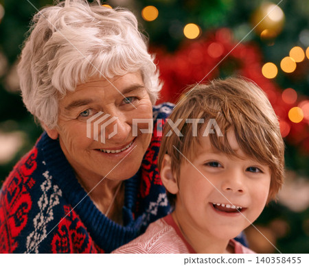 Christmas, portrait and celebration in living room, grandma and grandchild smile with happiness. House, elderly woman and kid together for holiday as family in lounge, tree and love in home Christmas, portrait and celebration in living room, grandma and grandchild smile with happiness. House, elderly woman and kid together for holiday as family in lounge, tree and love in home 140358455