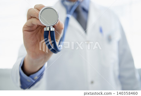 Doctor, hand and stethoscope or cardiology consultation or heart rate listening for healthcare, wellness or treatment. Medical person, equipment and monitor or virus service, diagnosis or examination 140358460