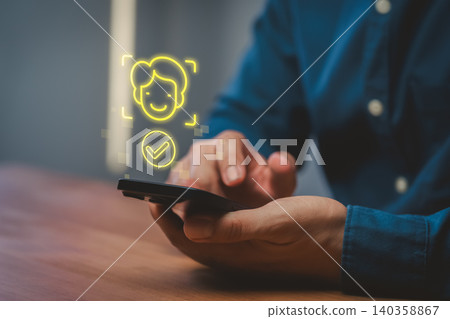 Man using smartphone for face ID biometric facial recognition authentication. Secure mobile technology for digital identification, verification and access control on cell phone device. Man using smartphone for face ID biometric facial recognition authentication. Secure mobile technology for digital identification, verification and access control on cell phone device. 140358867