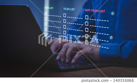 Businessman using laptop for productivity task management with to-do list and not-to-do list. Work planning, project efficiency, and time management concept on computer device. Businessman using laptop for productivity task management with to-do list and not-to-do list. Work planning, project efficiency, and time management concept on computer device. 140358868