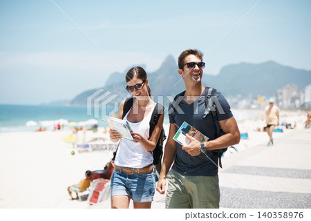Couple, map and beach with smile in summer, thinking or excited with search for direction on vacation. Woman, man and chart for location, landmark and travel for memory by sea with nature in Italy 140358976