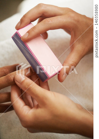 Hands, manicure and buffing nails in salon for beauty treatment, relax or care. Closeup, spa or tool on fingernail for polish at cosmetic service with professional, customer and cleaning for wellness Hands, manicure and buffing nails in salon for beauty treatment, relax or care. Closeup, spa or tool on fingernail for polish at cosmetic service with professional, customer and cleaning for wellness 140358980