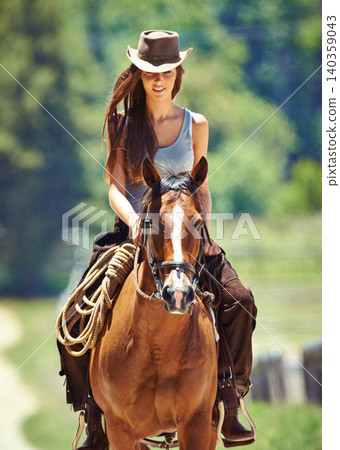 Woman, cowgirl and horse riding in the countryside for journey, travel or outdoor adventure in nature. Female person or western rider with hat, saddle and animal stallion at ranch, farm or stable Woman, cowgirl and horse riding in the countryside for journey, travel or outdoor adventure in nature. Female person or western rider with hat, saddle and animal stallion at ranch, farm or stable 140359043