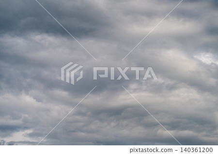 Thick grey layer indicating impending storm. Overcast sky with heavy clouds forecast rain shortly. Dense grey cloud cover signals imminent rainstorm with intense atmosphere Thick grey layer indicating impending storm. Overcast sky with heavy clouds forecast rain shortly. Dense grey cloud cover signals imminent rainstorm with intense atmosphere 140361200