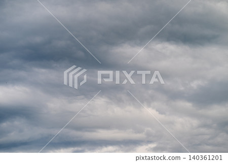 Gray cloudy sky. Cloudy sky with soft shadows. Overcast clouds with muted colors and calm atmosphere. Sky covered with clouds casting gentle shadows and subdued hues Gray cloudy sky. Cloudy sky with soft shadows. Overcast clouds with muted colors and calm atmosphere. Sky covered with clouds casting gentle shadows and subdued hues 140361201