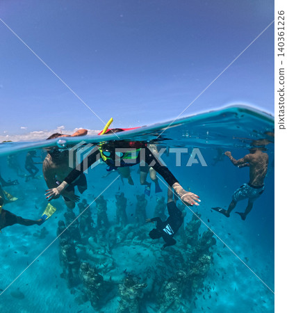 Snorkeling adventure over tropical coral reefs with colorful fish in crystal clear waters. Snorkeling adventure over tropical coral reefs with colorful fish in crystal clear waters. 140361226