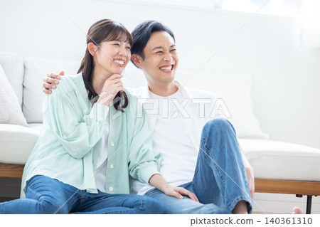 Lifestyle: A couple relaxing in the living room Lifestyle: A couple relaxing in the living room 140361310