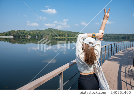 Rear view of female tourist while visiting Mae Puem National Park in Phayao province of Thailand. Rear view of female tourist while visiting Mae Puem National Park in Phayao province of Thailand. 140361400